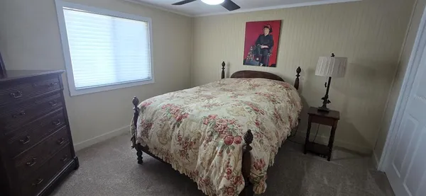 a bed sitting in a bedroom next to a window