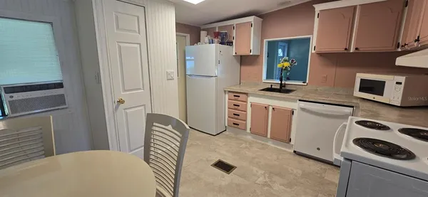 a kitchen with stainless steel appliances a refrigerator stove and microwave