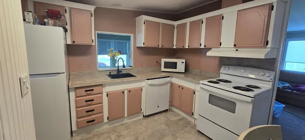 a kitchen with stainless steel appliances granite countertop a refrigerator and a stove
