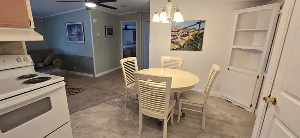 a kitchen with a table chairs and a stove