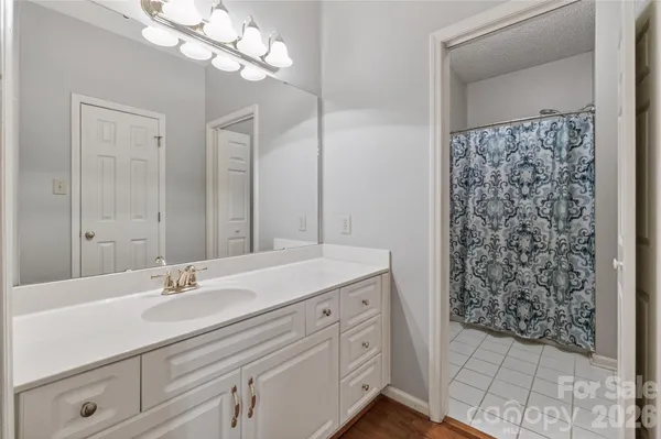 a bathroom with a sink a vanity and a mirror