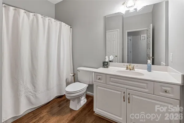 a bathroom with a sink toilet and a mirror
