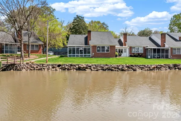 a front view of a house with a lake view