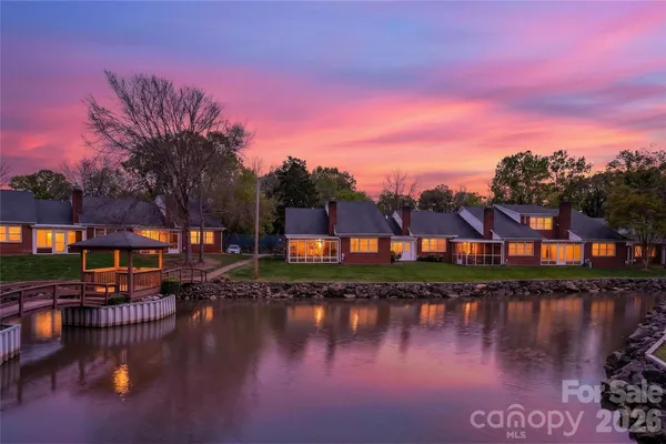 a view of residential houses with outdoor space and lake view