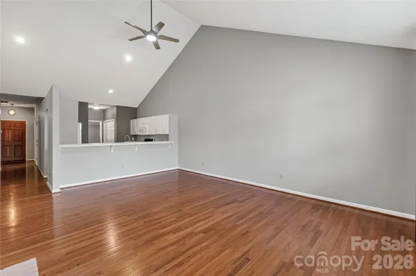 a view of a kitchen with wooden floor and a kitchen space