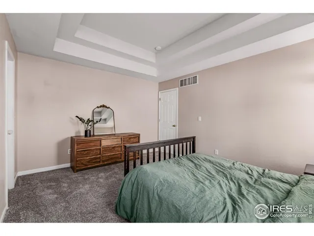 a bedroom with a bed and a table