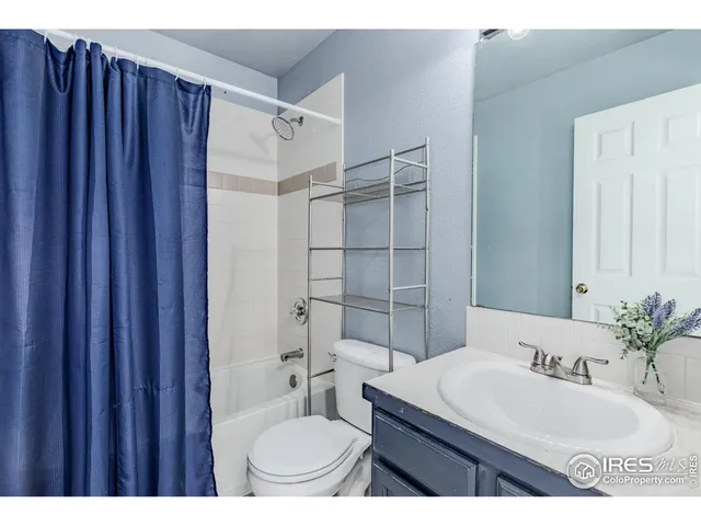 a bathroom with a sink toilet a mirror and shower