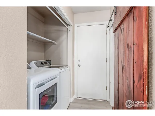 a view of storage and utility room with washer and dryer