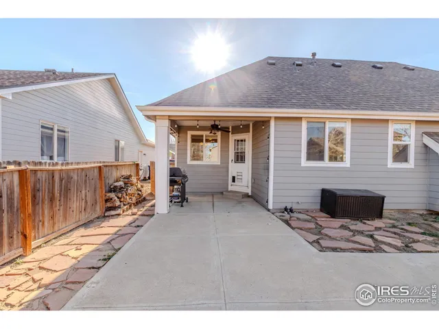 a view of a house with wooden fence