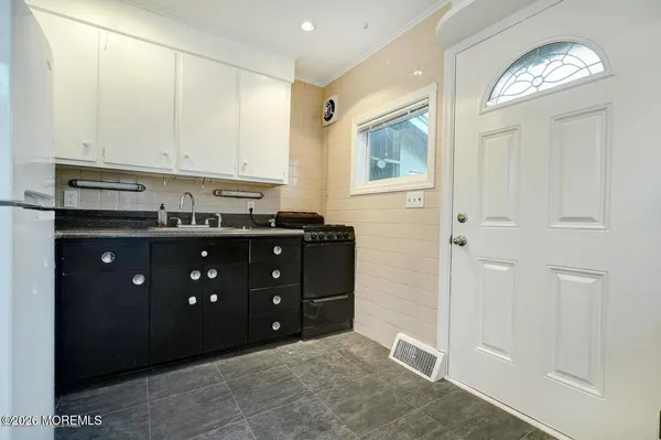 a room with a cabinets and a mirror