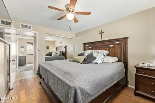 a bedroom with bed and wooden floor
