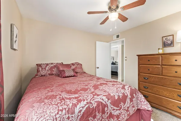 a bedroom with a large bed and a chandelier
