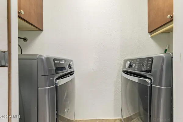 a metallic refrigerator freezer sitting in a kitchen