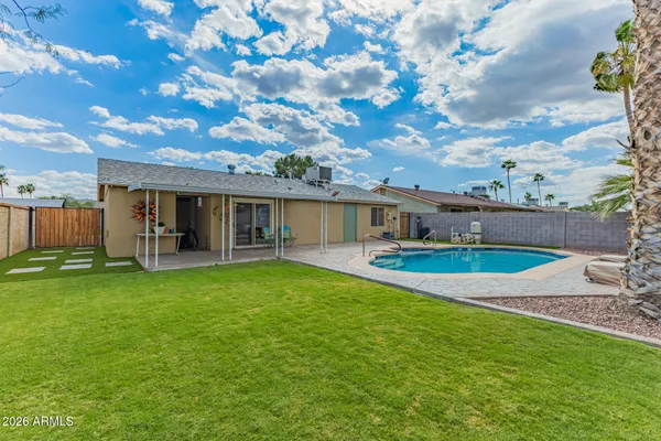 a view of a house with a backyard porch and sitting area