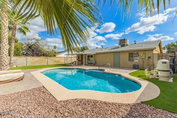 a view of a house with swimming pool and sitting area