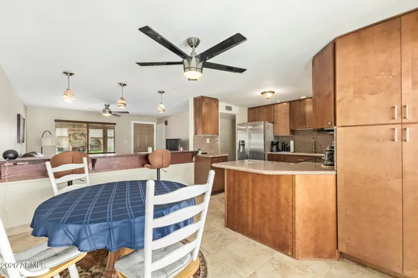 a living room with stainless steel appliances furniture and a large window