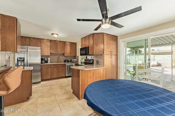 a kitchen with granite countertop a stove cabinets and refrigerator
