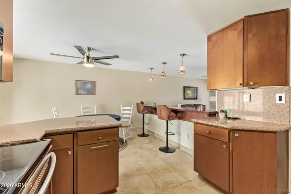a kitchen with a sink appliances and cabinets