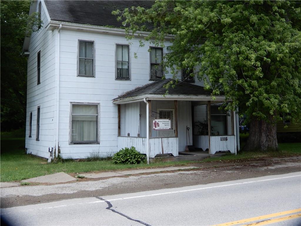 1185 Franklin Road Jackson Center, PA 16133 - Photo 1 of 16 a front view of a house with a garden