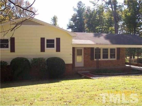 4110 Jimmy Rogers Road Durham, NC 27703 - Photo 1 of 14 a front view of a house with a yard