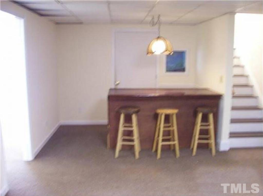4110 Jimmy Rogers Road Durham, NC 27703 - Photo 12 of 14 a room with a chandelier and a fireplace