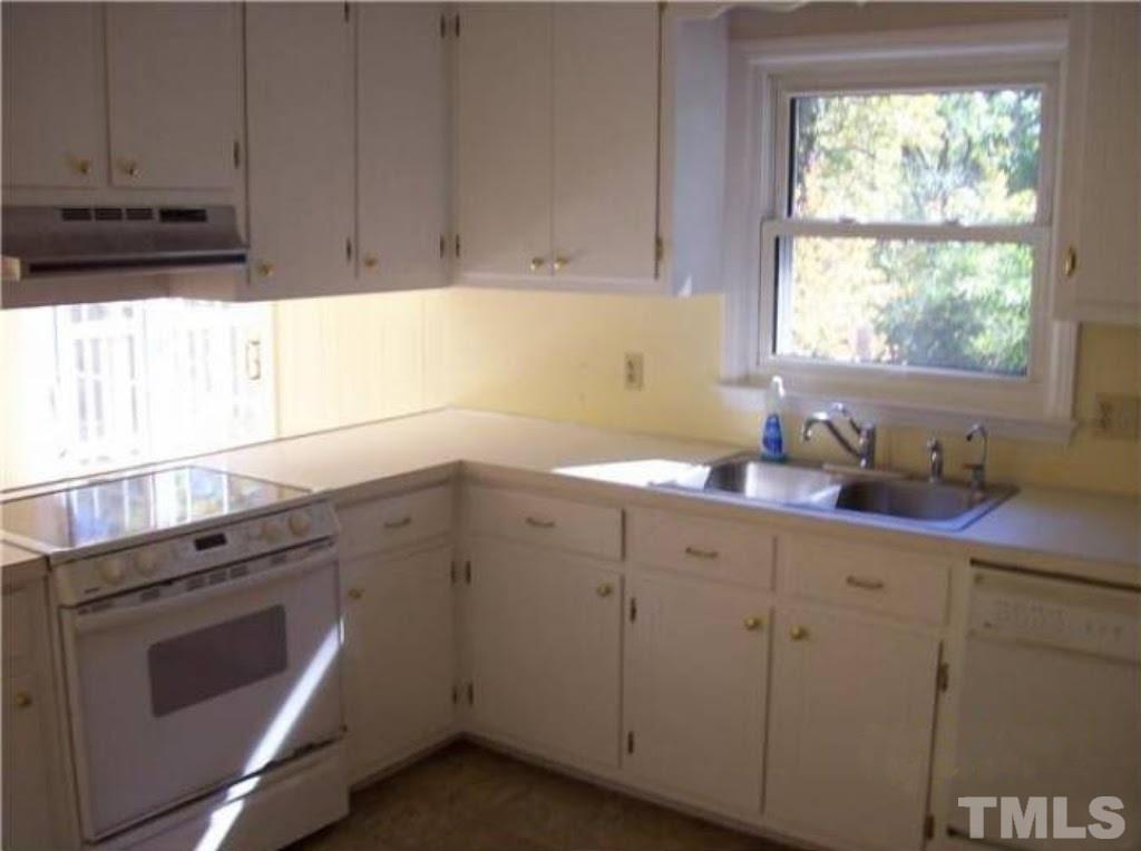 4110 Jimmy Rogers Road Durham, NC 27703 - Photo 3 of 14 a kitchen with a sink cabinets appliances and a window