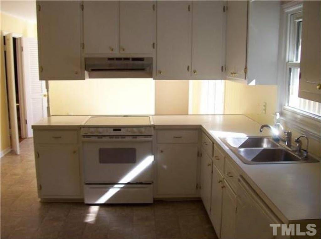 4110 Jimmy Rogers Road Durham, NC 27703 - Photo 4 of 14 a kitchen with a sink cabinets and a window