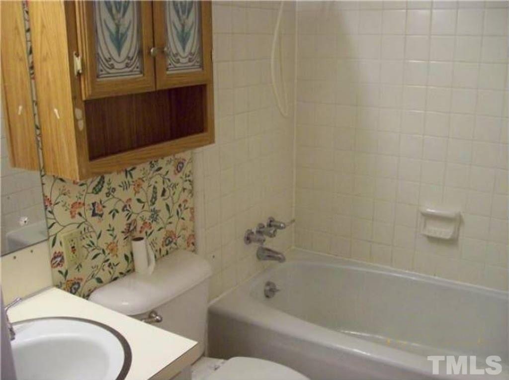 4110 Jimmy Rogers Road Durham, NC 27703 - Photo 9 of 14 a bathroom with a toilet and a bathtub
