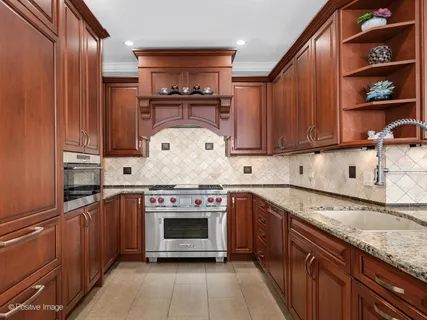 a kitchen with stainless steel appliances granite countertop a stove and a sink