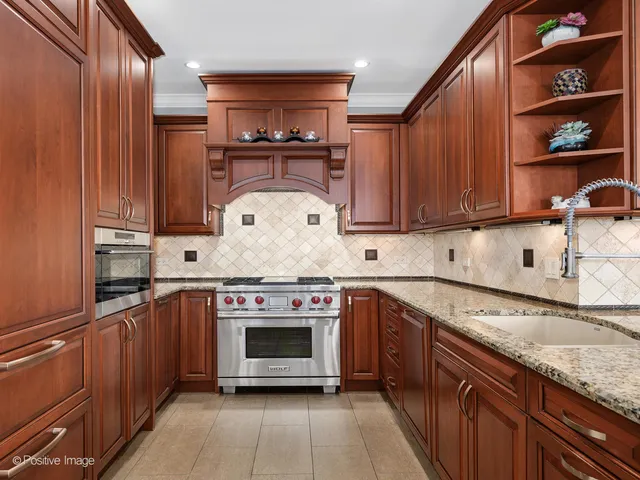 a kitchen with stainless steel appliances granite countertop a stove and a sink