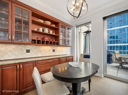 a view of a dining room with furniture and chandelier