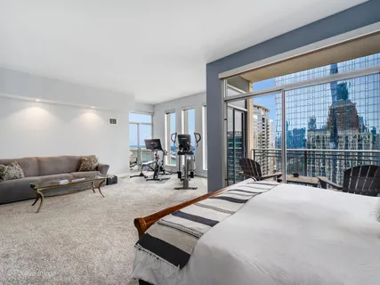 a bedroom with furniture and a large window