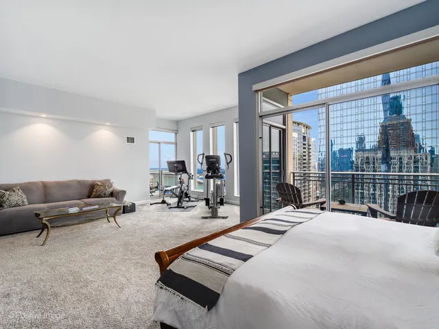 a bedroom with furniture and a large window