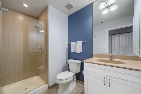 a bathroom with a sink toilet vanity and shower