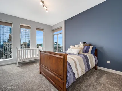 a bed sitting in a bedroom next to a balcony