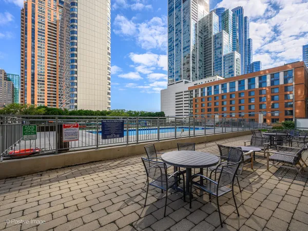 a balcony with table and chairs