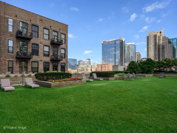 a view of a city with tall buildings and a big yard