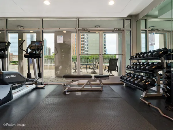 a room with gym equipment and floor to ceiling window