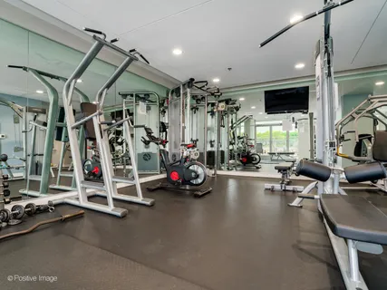 a view of a gym with gym equipment