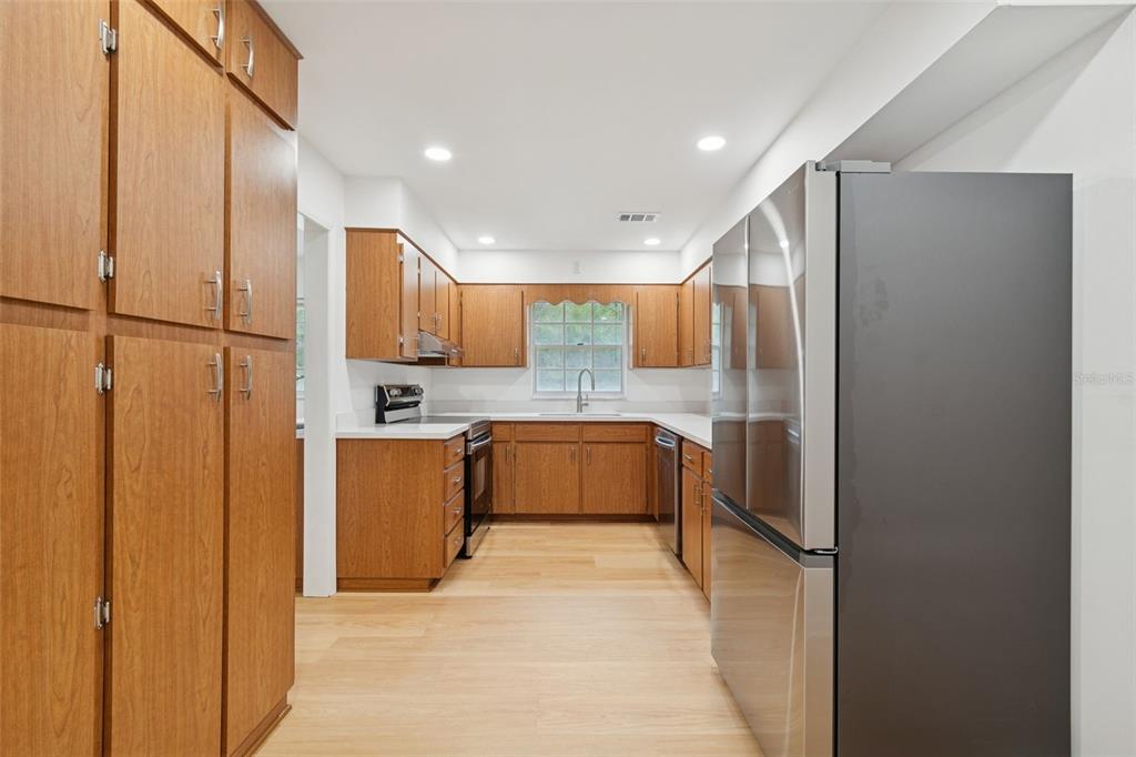 7011 Southwest 170th Street Archer, FL 32618 - Photo 12 of 35 a large kitchen with stainless steel appliances granite countertop a refrigerator and a sink