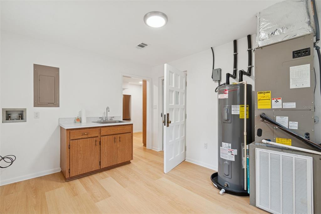 7011 Southwest 170th Street Archer, FL 32618 - Photo 14 of 35 a large kitchen with stainless steel appliances granite countertop a refrigerator and a stove top oven