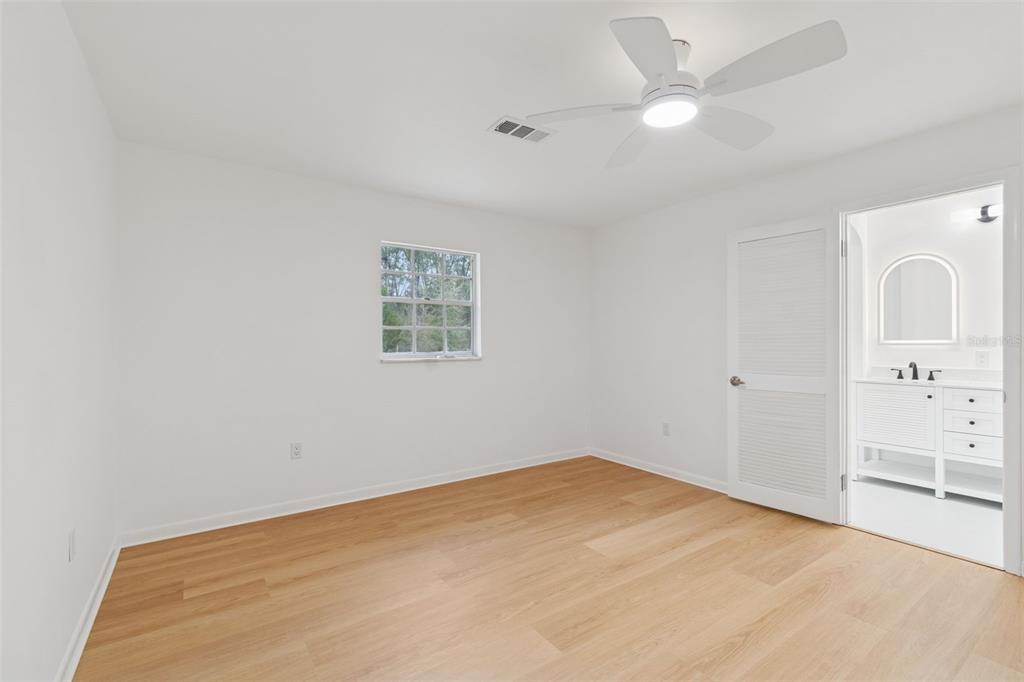 7011 Southwest 170th Street Archer, FL 32618 - Photo 17 of 35 an empty room with windows and fan