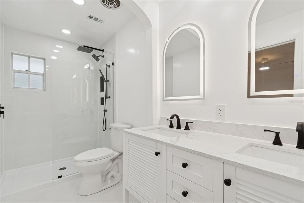 7011 Southwest 170th Street Archer, FL 32618 - Photo 19 of 35 a bathroom with a double vanity sink toilet and shower