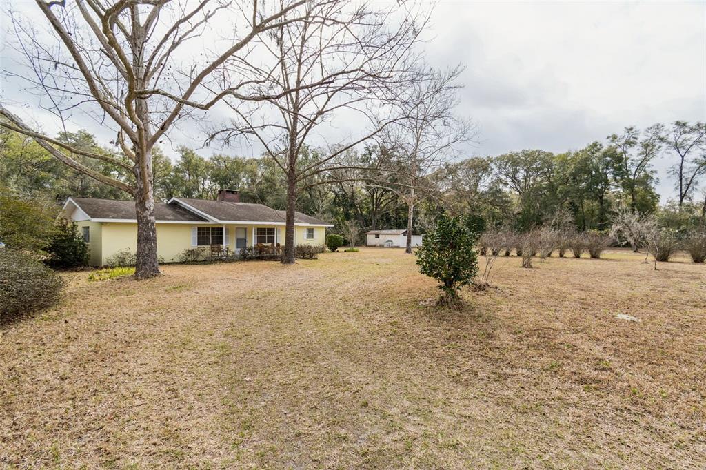 7011 Southwest 170th Street Archer, FL 32618 - Photo 32 of 35 a road view with large trees