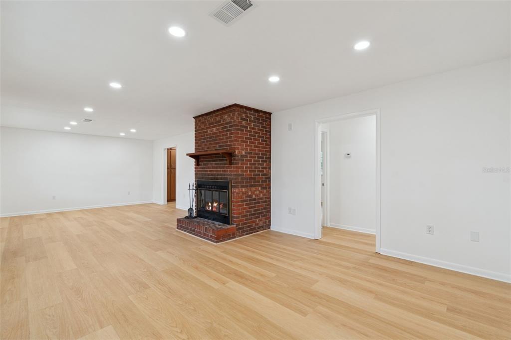 7011 Southwest 170th Street Archer, FL 32618 - Photo 5 of 35 a view of an empty room with a fireplace