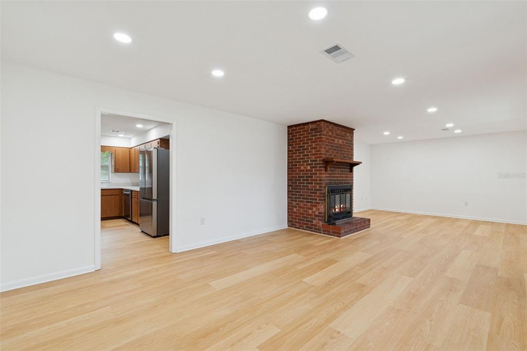 7011 Southwest 170th Street Archer, FL 32618 - Photo 6 of 35 a view of an empty room with wooden floor and a bathroom