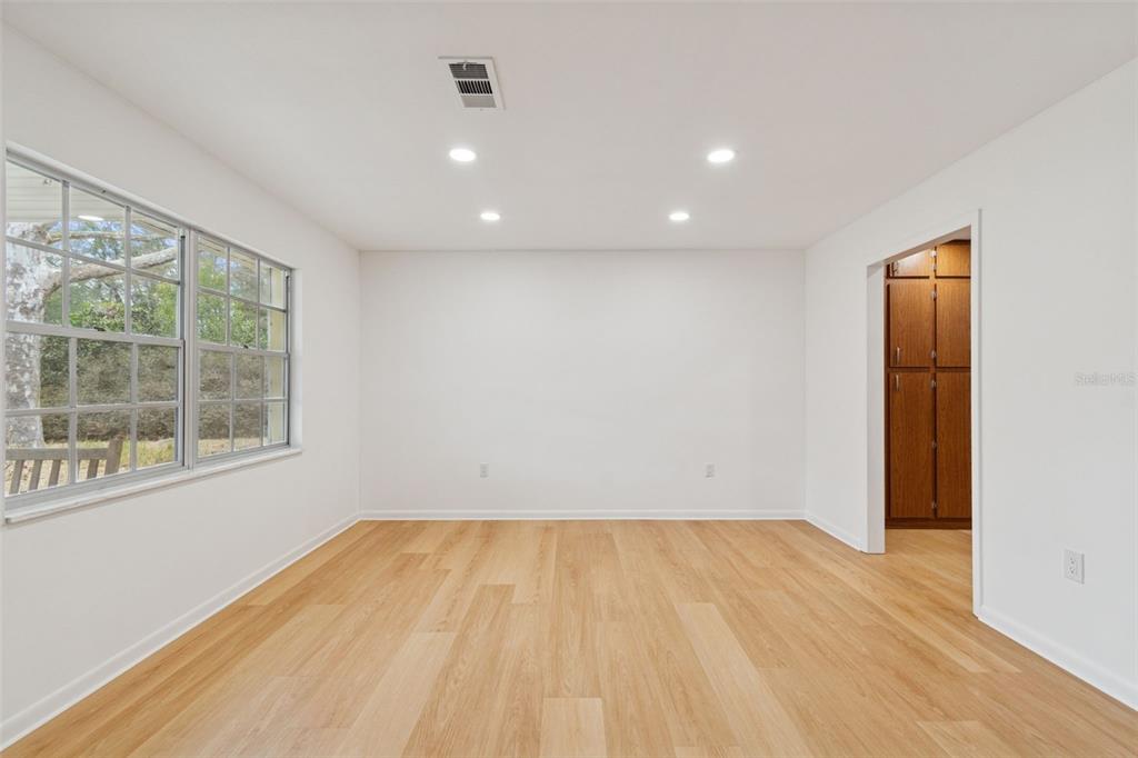 7011 Southwest 170th Street Archer, FL 32618 - Photo 7 of 35 an empty room with wooden floor and windows
