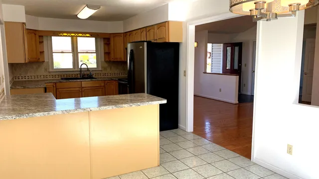 a kitchen with a refrigerator and a stove