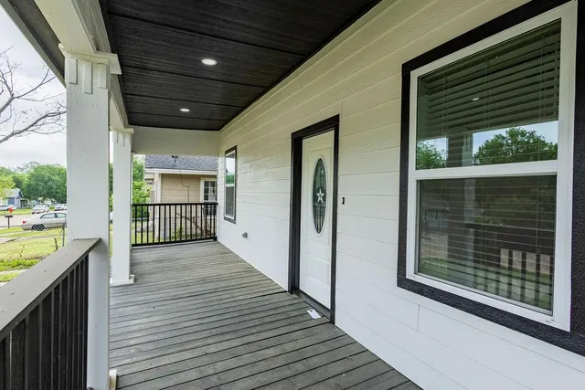 a view of a balcony with wooden floor