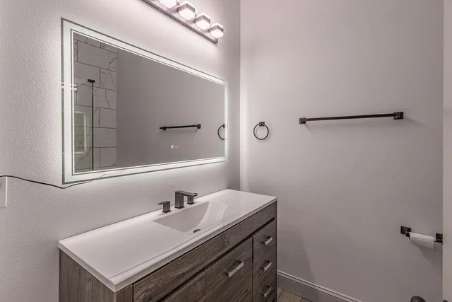 a bathroom with a sink and a mirror
